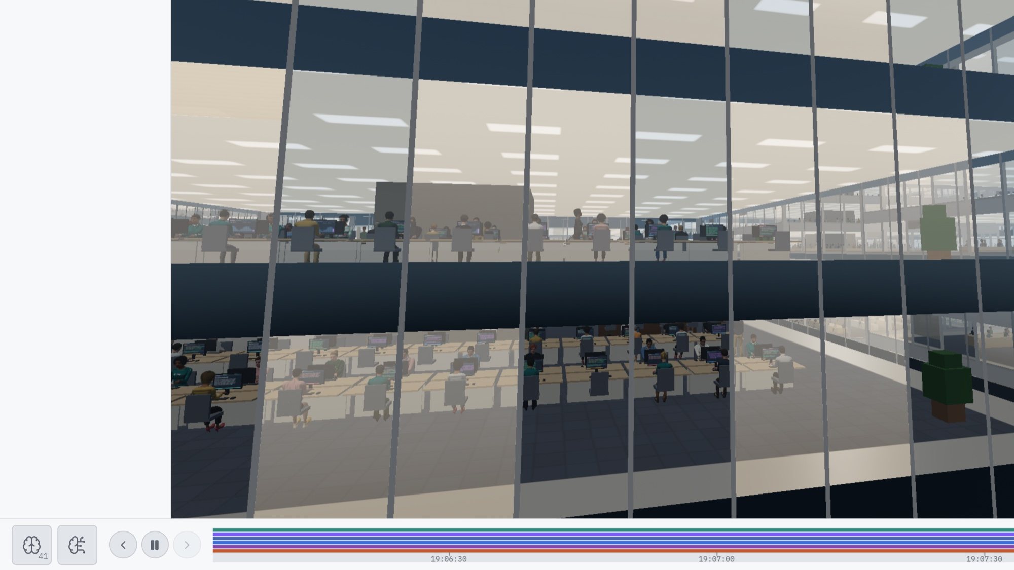 Looking through a tower’s glass from outside at two floors of people working at their desks